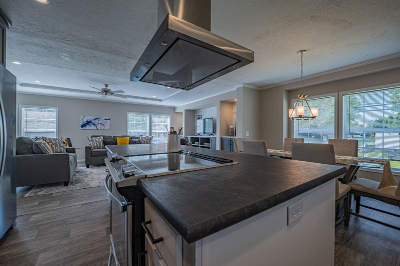 Open-concept kitchen and living room in a modern manufactured home at Columbia Park Olmsted Township Ohio